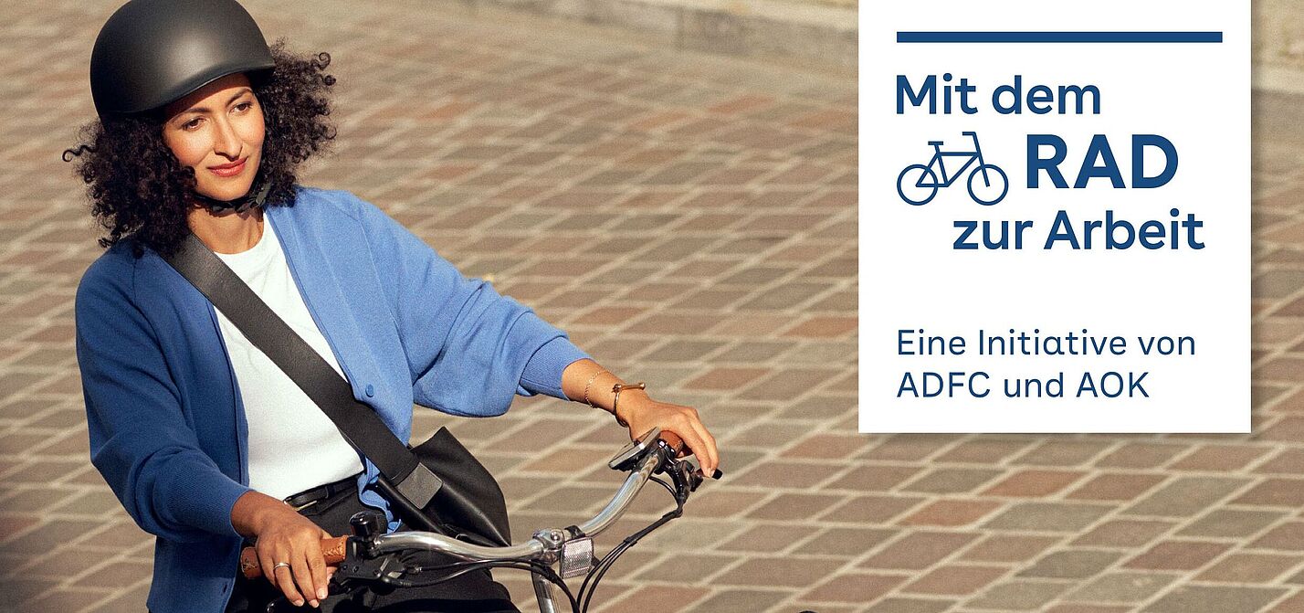 Mit dem Rad zur Arbeit 2023 Eine Frau fährt mit einem Lastenrad.